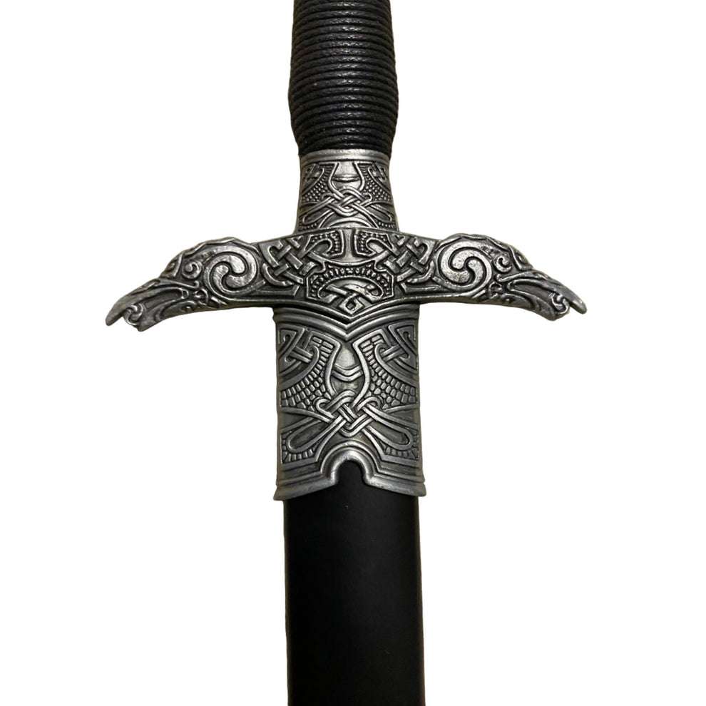Decorative sword handle with intricate metalwork on a white background