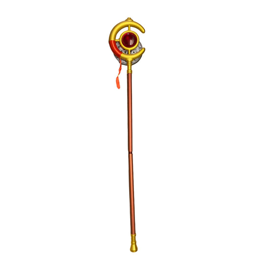 Decorative staff with a red gem and gold accents on a counter.
