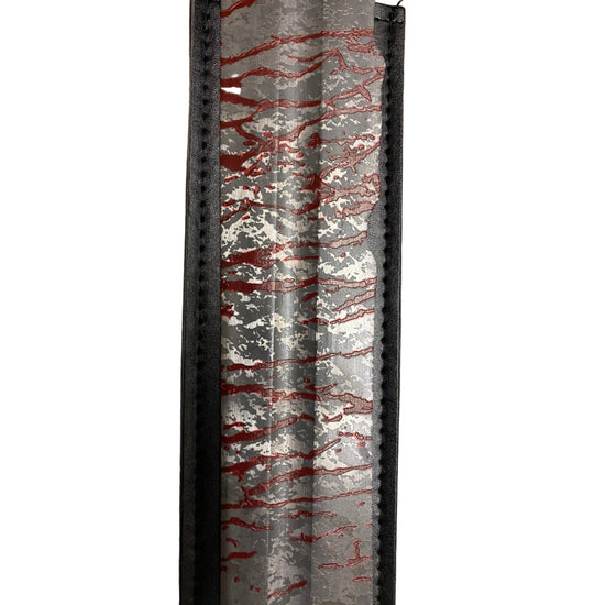 Decorative item with red and white pattern on a gray background